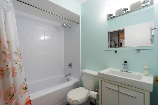 Bathroom featuring toilet, shower / bath combo, and vanity | Image 17