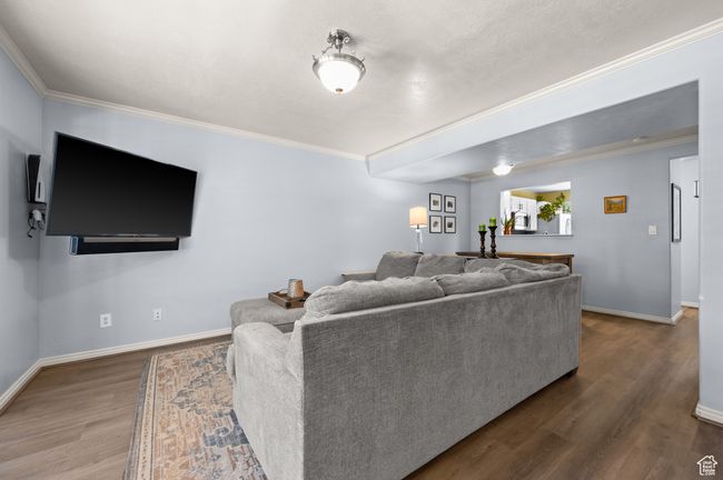 Living room featuring wood finished floors and ornamental molding | Image 6