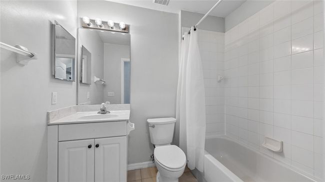 Bathroom with shower / tub combo, vanity, visible vents, and toilet | Image 11