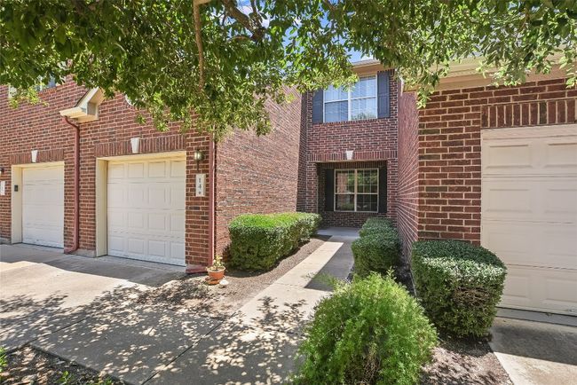 View of front of property featuring brick siding and a garage | Image 4