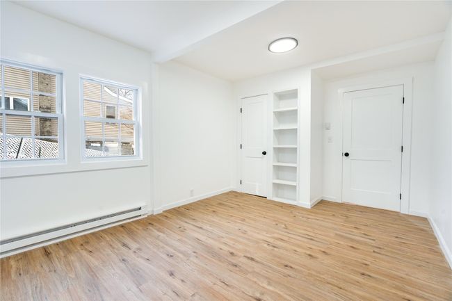 Unfurnished room with baseboard heating, beamed ceiling, baseboards, and light wood-style floors | Image 14