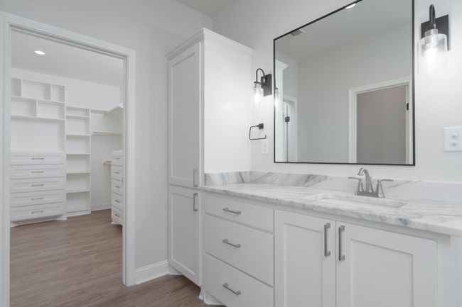 Bathroom featuring a spacious closet, vanity, and wood finished floors | Image 24