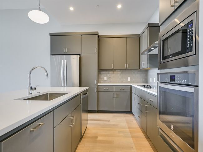 Kitchen also features ample cabinet storage, large single basin sink, Groehe water faucet, and a convenient pull-out trash drawer. | Image 7