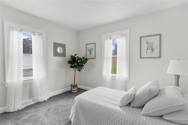 Bedroom featuring multiple windows and carpet floors | Image 12