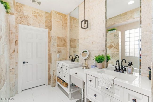 Bathroom featuring tile walls, two vanities, and tile patterned flooring | Image 16