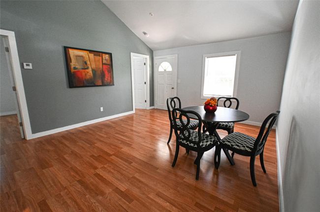 Dining space featuring lofted ceiling and wood finished floors | Image 13