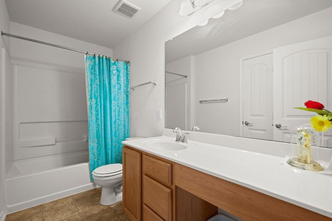 Full bath featuring vanity and shower / bath combo with shower curtain | Image 20