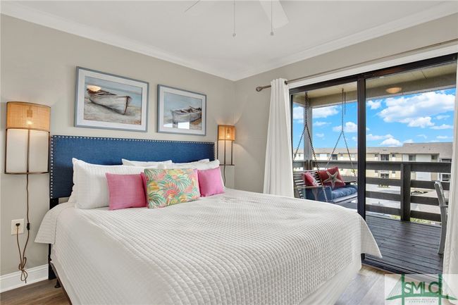 Primary Bedroom with En-Suite Bathroom & Sliding Glass Door leading to Spacious Balcony with Pool View | Image 19
