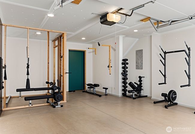 One car garage with pre-framed sauna space. Wired for an electric sauna heater. Home gym equipment is virtually staged. | Image 39