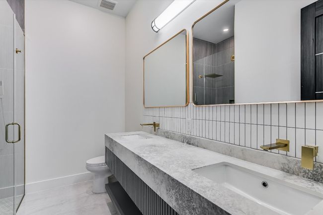 Full bath featuring a stall shower and double vanity | Image 32