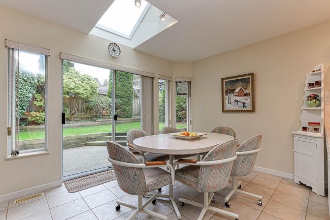 Dining room with light tile patterned floors, visible vents, and a healthy amount of sunlight | Image 14