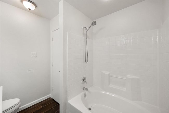 Full bath with wood tile floors and shower / washtub combination | Image 16
