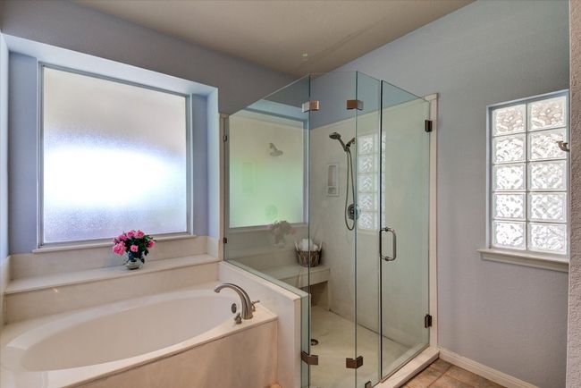 Primary shower and garden tub | Image 15