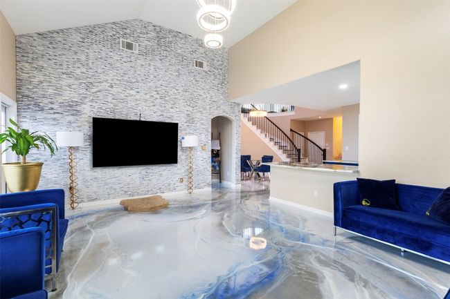 Unfurnished living room with stairway, high vaulted ceiling | Image 11