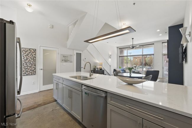 Kitchen featuring a sink, open floor plan, gray cabinets, ceiling fan, and stainless steel appliances | Image 15
