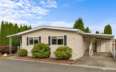 Covered Carport with Storage shed and covered back porch area. | Image 2