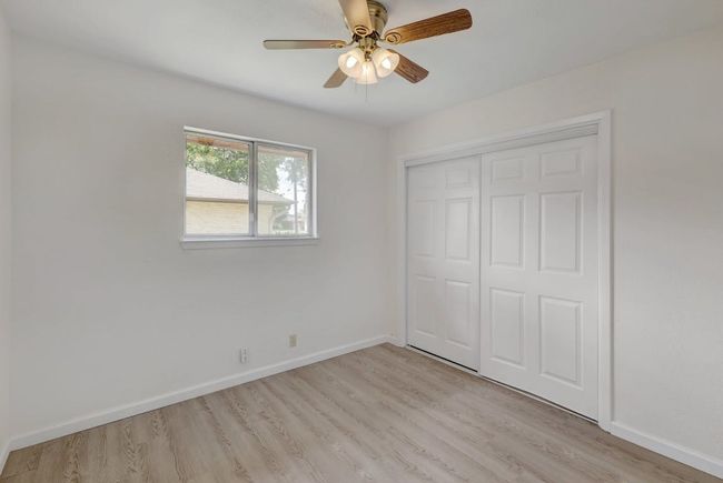 Unfurnished bedroom featuring light wood-type flooring, baseboards, and a closet | Image 18