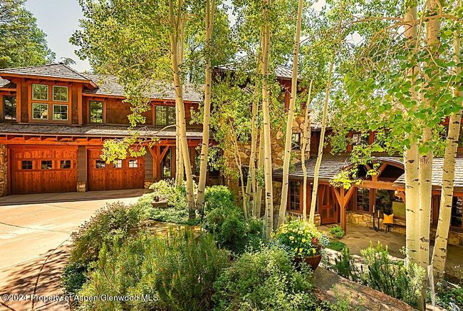 3-car garage and snowmelted "apron" at garage-end of driveway. Perennial gardens flank steps to front door. | Image 5