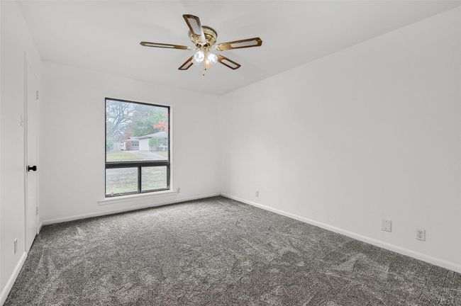 Spare room featuring carpet floors, ceiling fan, and baseboards | Image 27