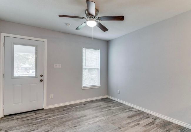 Entrance foyer with baseboards, light wood-type flooring, and a ceiling fan | Image 9