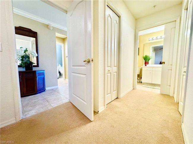 Corridor with ornamental molding, baseboards, and carpet floors | Image 19