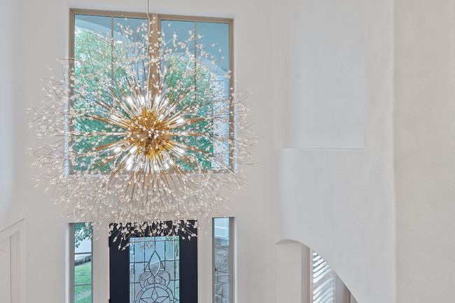 Detailed view of a chandelier and arched walkways | Image 4