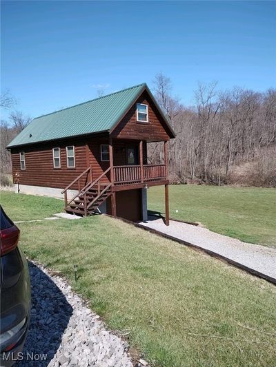 Front view of Log Home with over an acre of yard! | Image 1