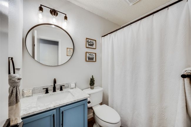 Full bath featuring toilet, vanity, and a shower with curtain | Image 24