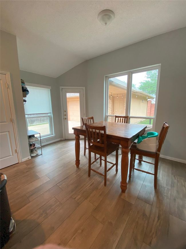 Dining room with vaulted ceiling, light wood-style floors, and plenty of natural light | Image 14