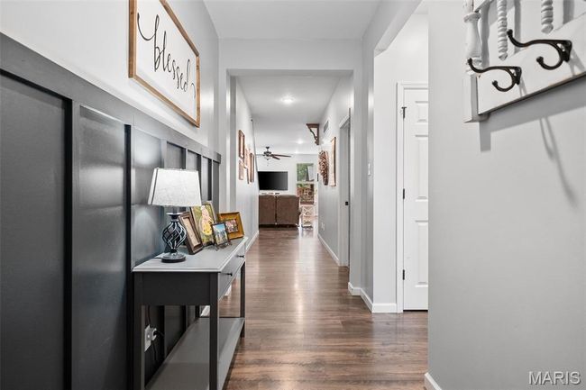 Hall with dark wood-style flooring and baseboards | Image 4