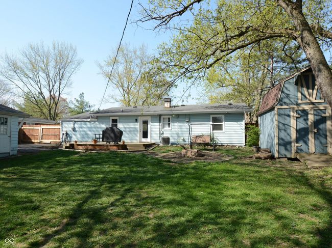 back of property with a storage shed, a lawn, fence, and an outdoor structure | Image 43