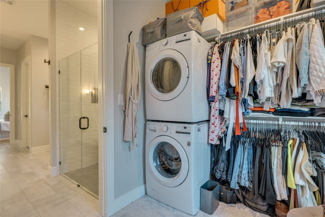 ENJOY THE LUXURY OF TWO LAUNDRY ROOMS! One in the primary closet and a full laundry upstairs with storage and sink. | Image 22