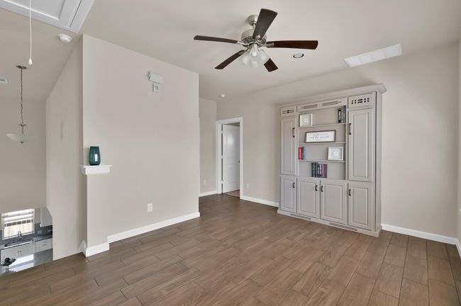 The tile floors continues up the stairs and into the common areas upstairs. The game room also includes a hidden Murphy bed in the book shelf! | Image 19
