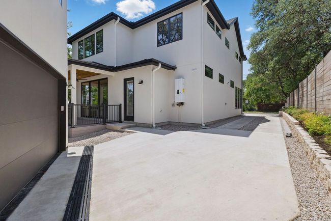 Rear view of house featuring stucco siding, fence, and a patio area | Image 28