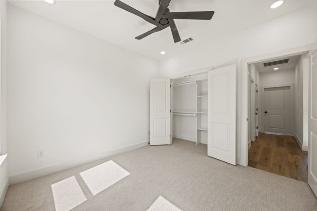 Unfurnished bedroom featuring carpet, recessed lighting, a closet, a ceiling fan, and baseboards | Image 21