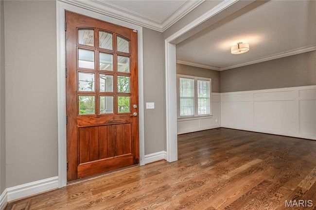 Entryway featuring ornamental molding and wood finished floors | Image 6