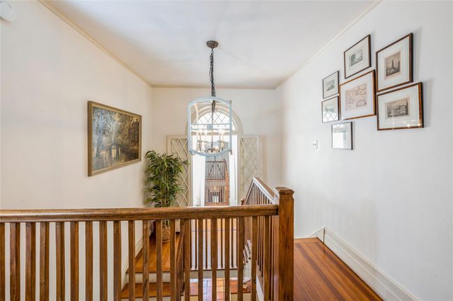 View of skylit entrance to north wing featuring two bedrooms and a beautifully renovated full bath. | Image 15