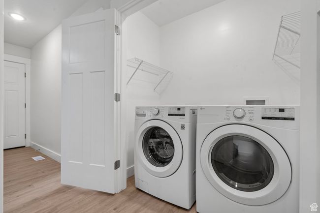 Washroom with independent washer and dryer, light wood-style flooring, and recessed lighting | Image 19