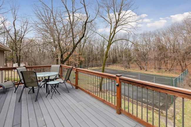 Large deck with low-maintenance Trex deck boards, ambient lighting, and idyllic setting | Image 41