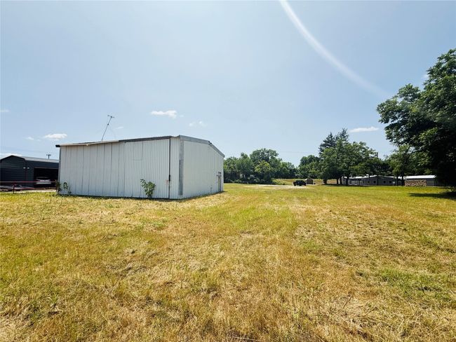 View of green lawn featuring an outbuilding | Image 12