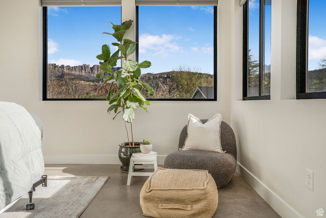 Living area with finished concrete floors and baseboards | Image 34