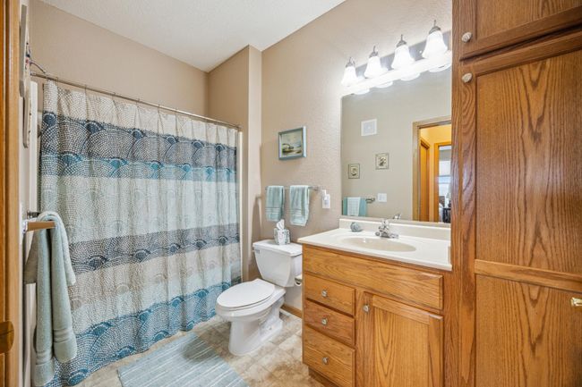 Second guest bath featuring a relaxing soaking tub with a shower head, an elevated countertop for added convenience, and a linen closet for extra storage. This condo also features 2 additional nice sized storage closets. | Image 19