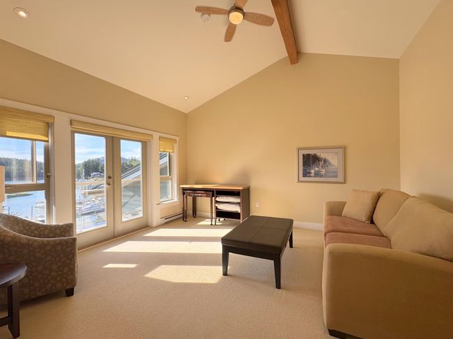 Carpeted living room with beam ceiling, french doors, ceiling fan, high vaulted ceiling, and recessed lighting | Image 26