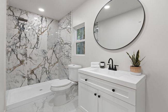 Bathroom featuring marble finish flooring, toilet, vanity, recessed lighting, and a marble finish shower | Image 19