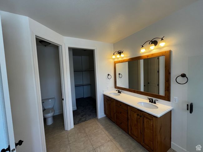 Bathroom featuring double vanity and tile patterned floors | Image 16