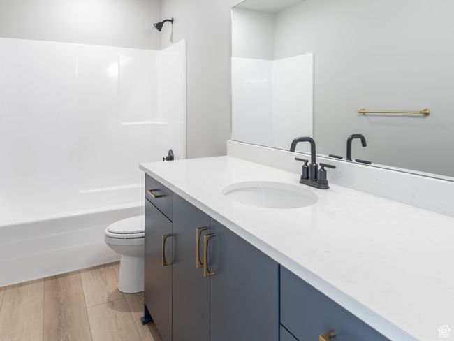 Bathroom featuring vanity, toilet, bathing tub / shower combination, and wood finished floors | Image 18