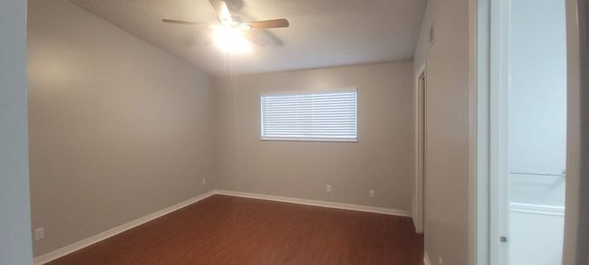 Unfurnished room featuring ceiling fan, dark wood-style floors, and a textured ceiling | Image 11