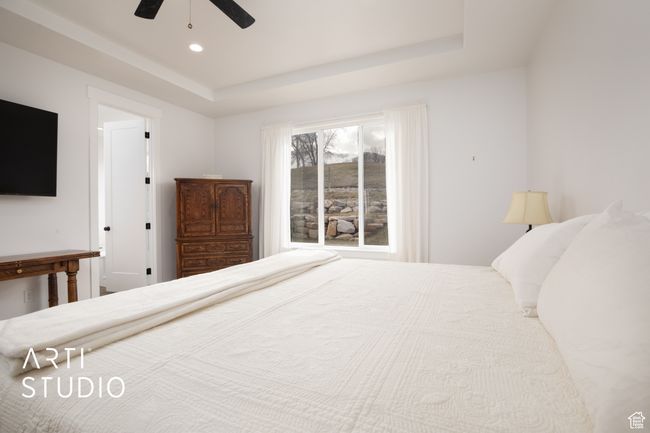 Bedroom with a raised ceiling and ceiling fan | Image 21