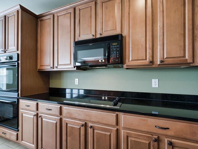 Kitchen featuring black appliances and dark countertops | Image 17