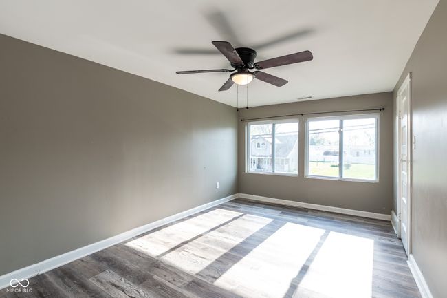spare room with baseboards, a ceiling fan, and wood finished floors | Image 27